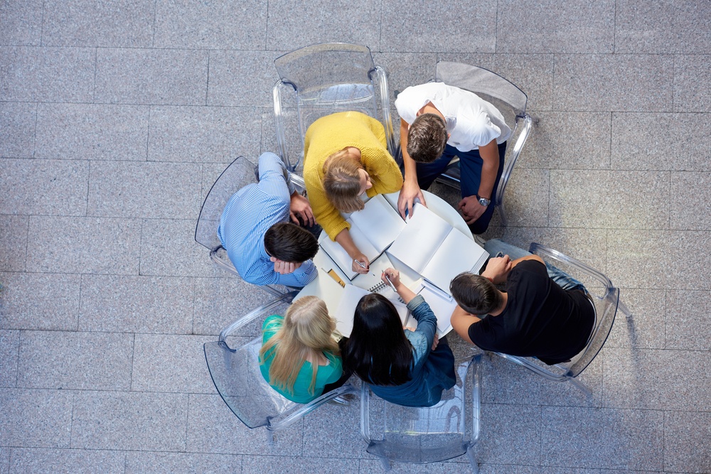 top view, group of students together at school table working homework and have fun.jpeg